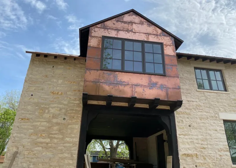 Copper metal panel facade on a stone building for Roof Repair in Monroeville