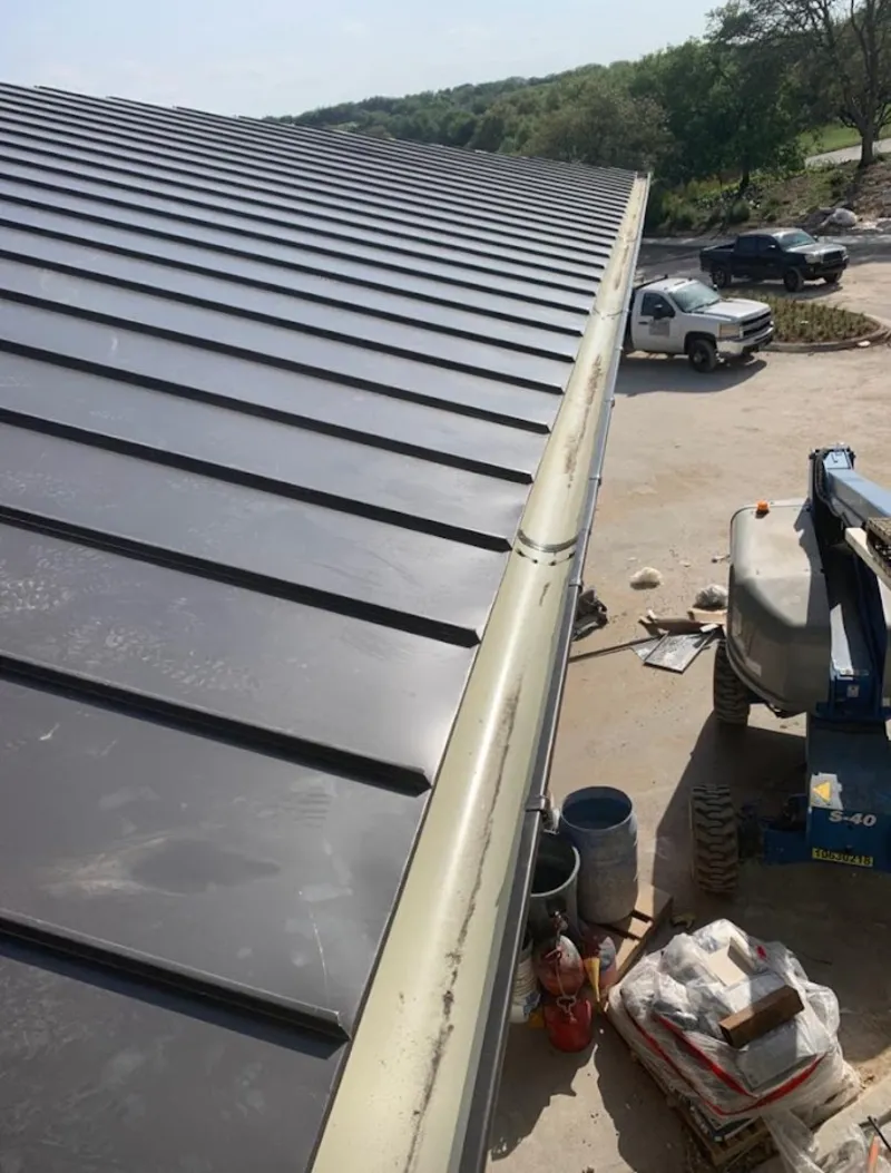 Standing seam panel and gutter detail on a metal roofing jobsite in Monroeville